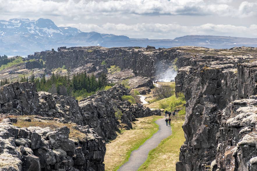 Visitors walking through Almannagja canyon at Thingvellir between the North American and Eurasian tectonic plates Visitors walking through Almannagja canyon at Thingvellir between the North American and Eurasian tectonic plates