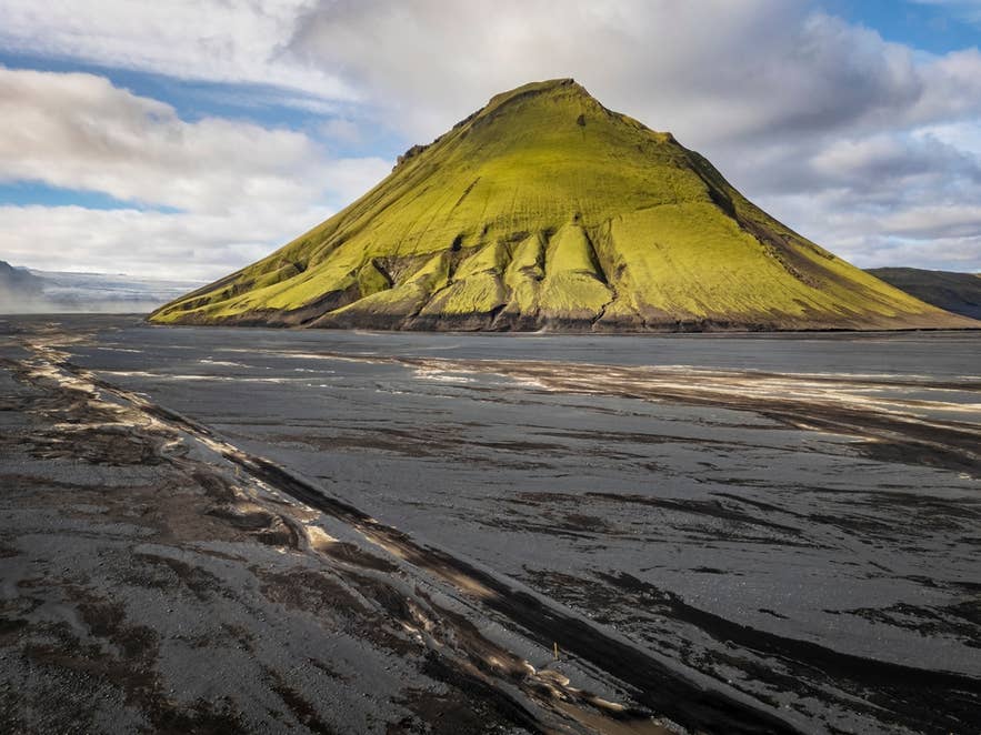 Maelifell stands in a barren volcanic plain, showing the harsh landscape shaped by loss of forests in Iceland.