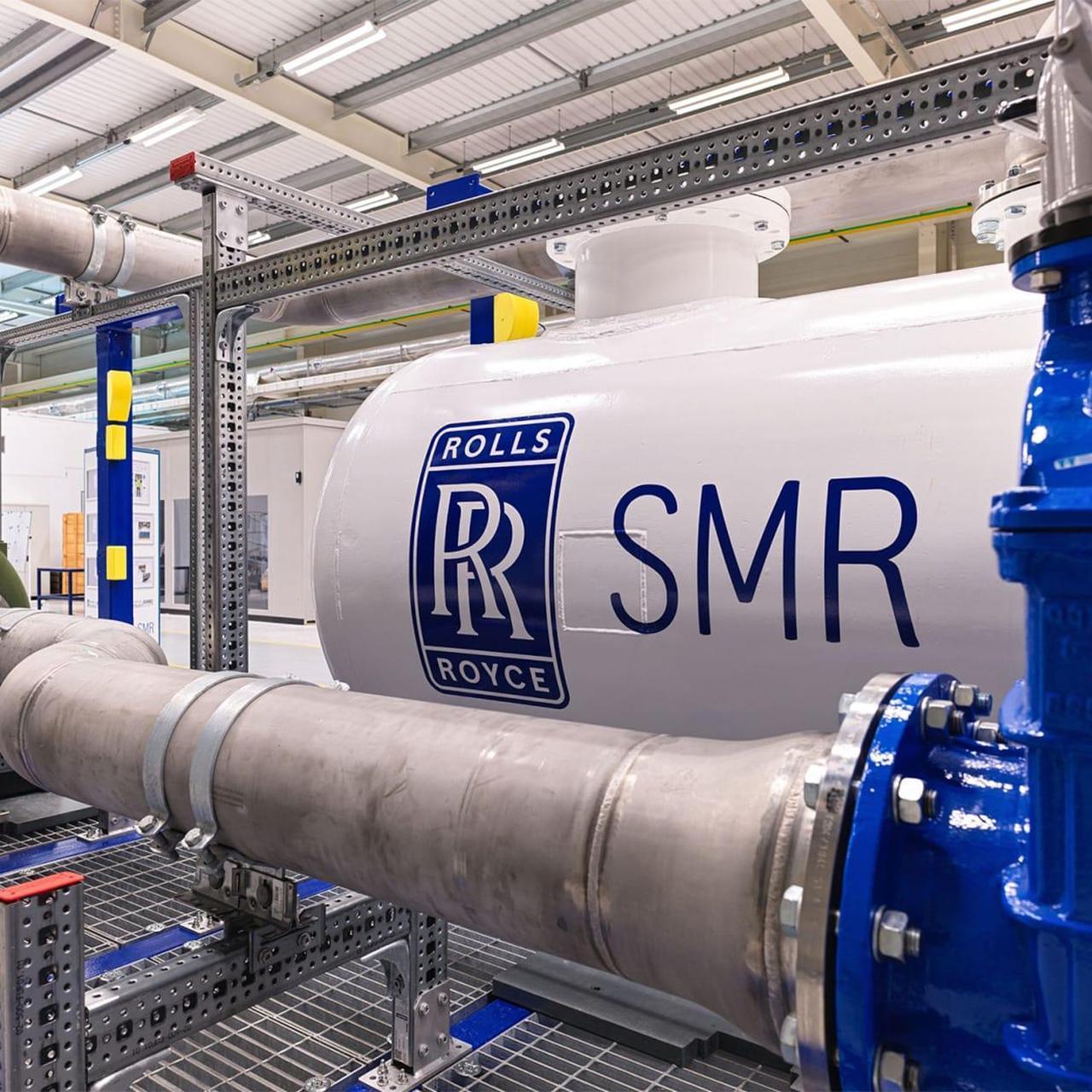 The image depicts a prototype or component of a Rolls-Royce Small Modular Reactor (SMR), a type of advanced nuclear power plant designed for factory fabrication and on-site assembly.