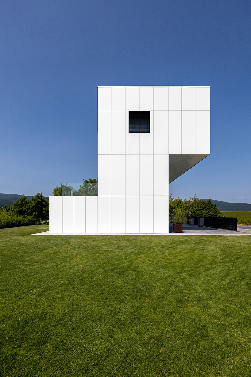 white aluminum cladding wraps tetris-like residence along lake in poland - 3