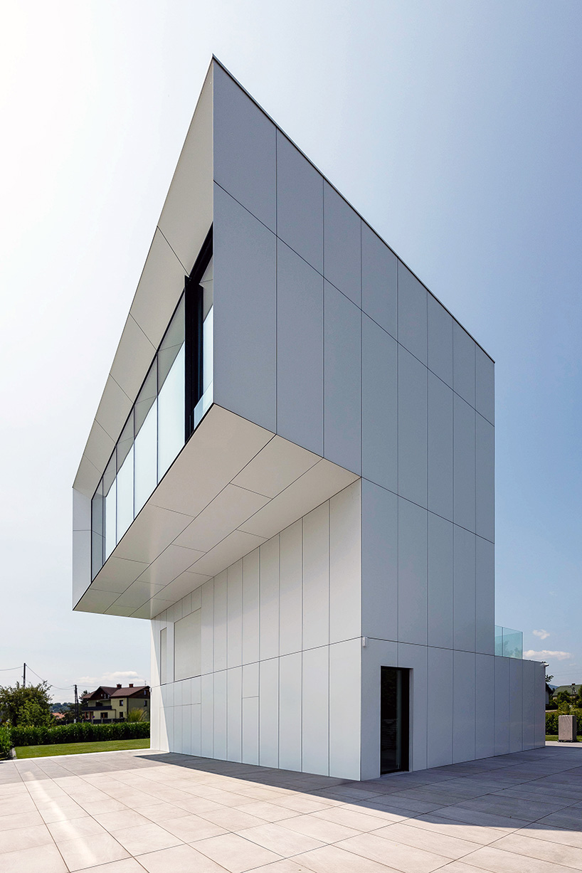 white aluminum cladding wraps tetris-like residence along lake in poland - 5