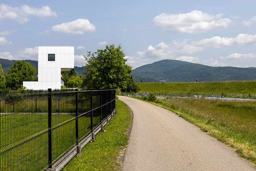 white aluminum cladding wraps tetris-like residence along lake in poland - 2