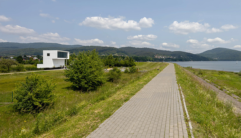white aluminum cladding wraps tetris-like residence along lake in poland - 1