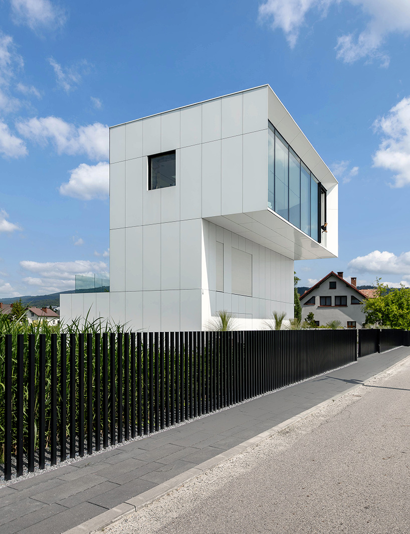 white aluminum cladding wraps tetris-like residence along lake in poland - 4