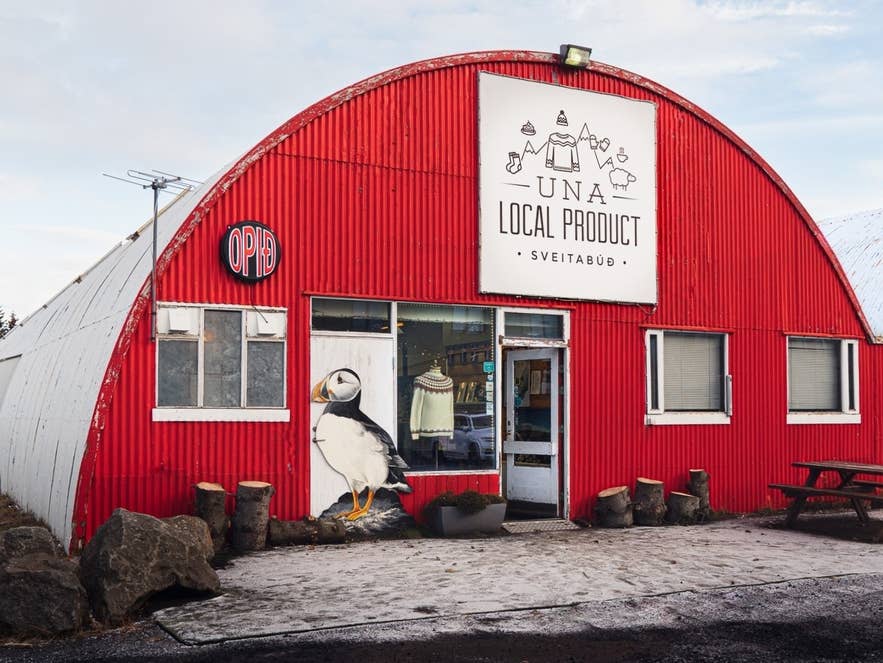 UNA Local Product store in Iceland selling handmade crafts and wool goods in a red corrugated building UNA Local Product store in Iceland selling handmade crafts and wool goods in a red corrugated building