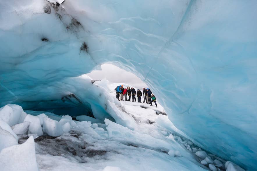 Group of hikers exploring an ice cave inside Vatnajokull glacier in Iceland. Group of hikers exploring an ice cave inside Vatnajokull glacier in Iceland.
