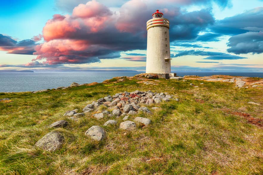 Skarsviti lighthouse on a grassy cliff in Iceland at sunset, with dramatic clouds and ocean views in the background. Skarsviti lighthouse on a grassy cliff in Iceland at sunset, with dramatic clouds and ocean views in the background.