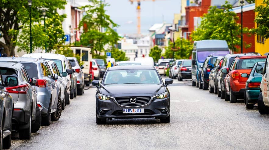Cars parked along Skolavordustigur in Reykjavik, where visitors can pay for parking easily using an Iceland app like EasyPark.