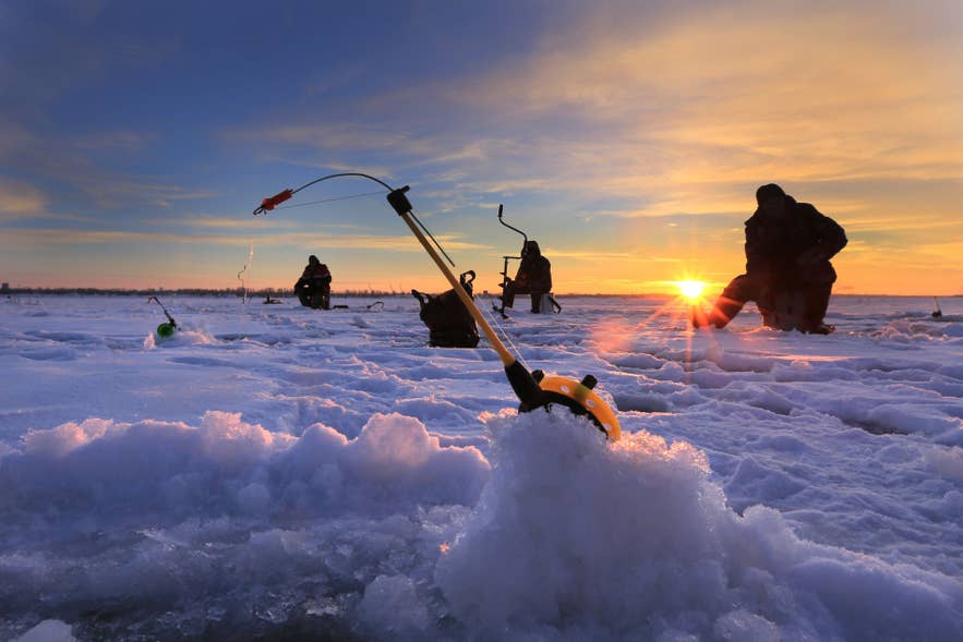 Winter ice fishing scene showing harsh iceland weather and snowy conditions
