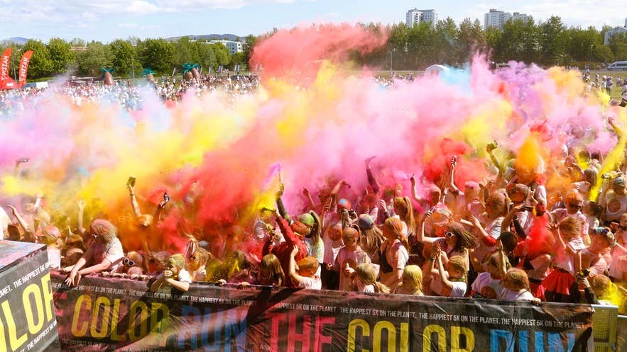 Crowd throws colored powder at the Color Run, a vibrant event that ranks among the top festivals in Iceland for all ages. Crowd throws colored powder at the Color Run, a vibrant event that ranks among the top festivals in Iceland for all ages.