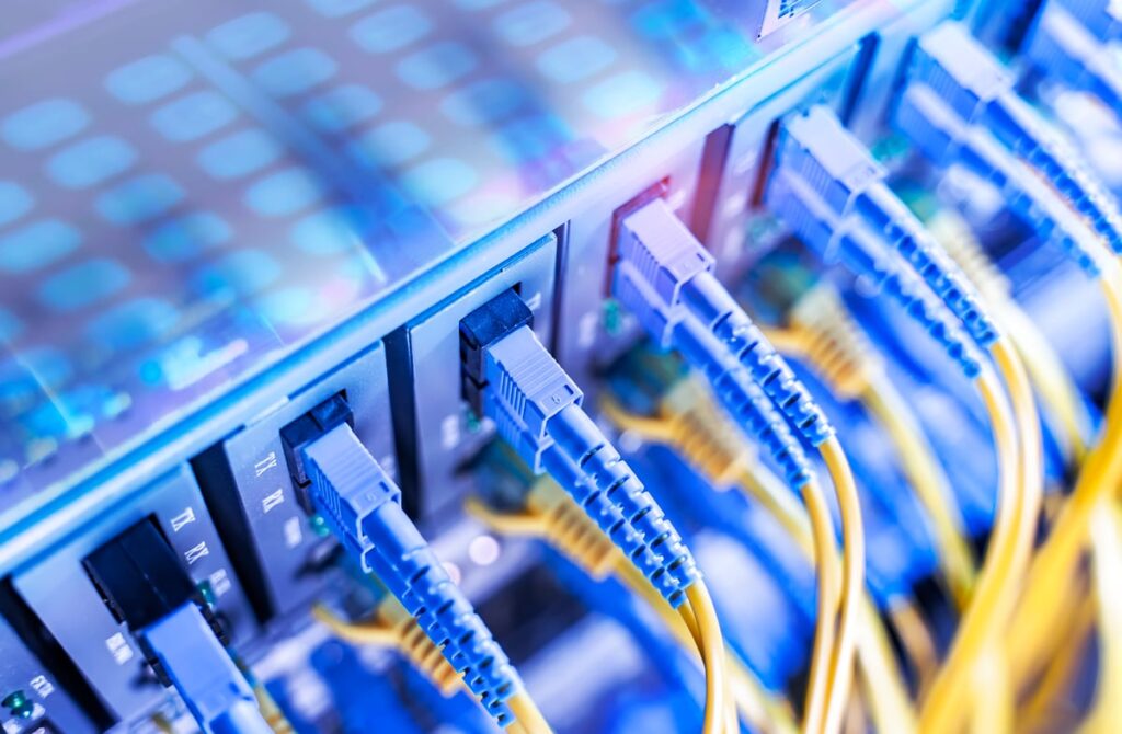 These Artificial Intelligence (AI) Stocks Have Crushed Nvidia in 2026 With Gains of 67% and 121%. They Can Still Soar Higher Blue and yellow cables plugged into servers.