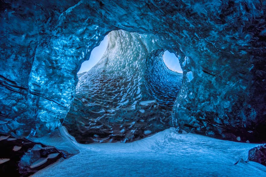 Blue ice cave inside Vatnajokull Glacier in South Iceland, where freezing conditions influence what to wear in Iceland. Blue ice cave inside Vatnajokull Glacier in South Iceland, where freezing conditions influence what to wear in Iceland.