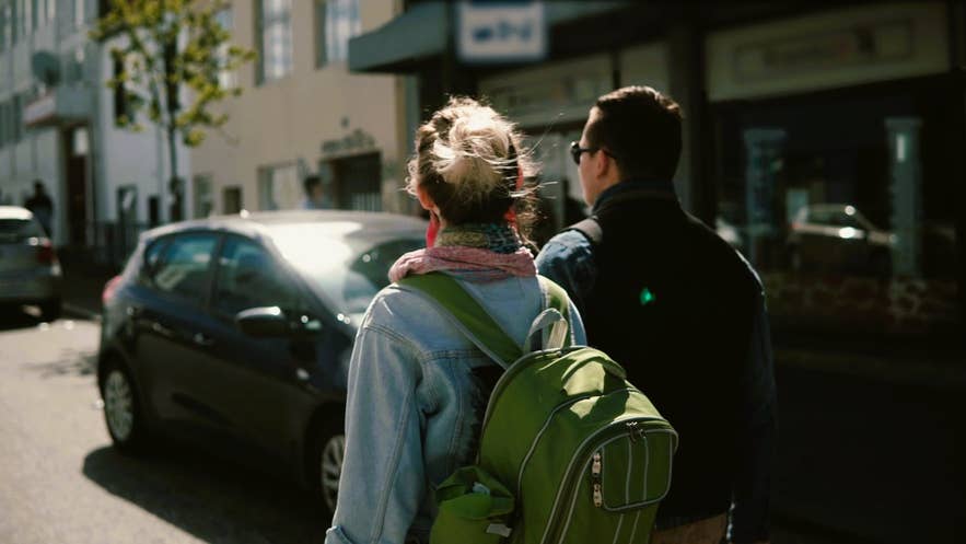 Travelers in light layers and backpacks in Reykjavik show what to wear in Iceland in summer for casual city exploration. Travelers in light layers and backpacks in Reykjavik show what to wear in Iceland in summer for casual city exploration.