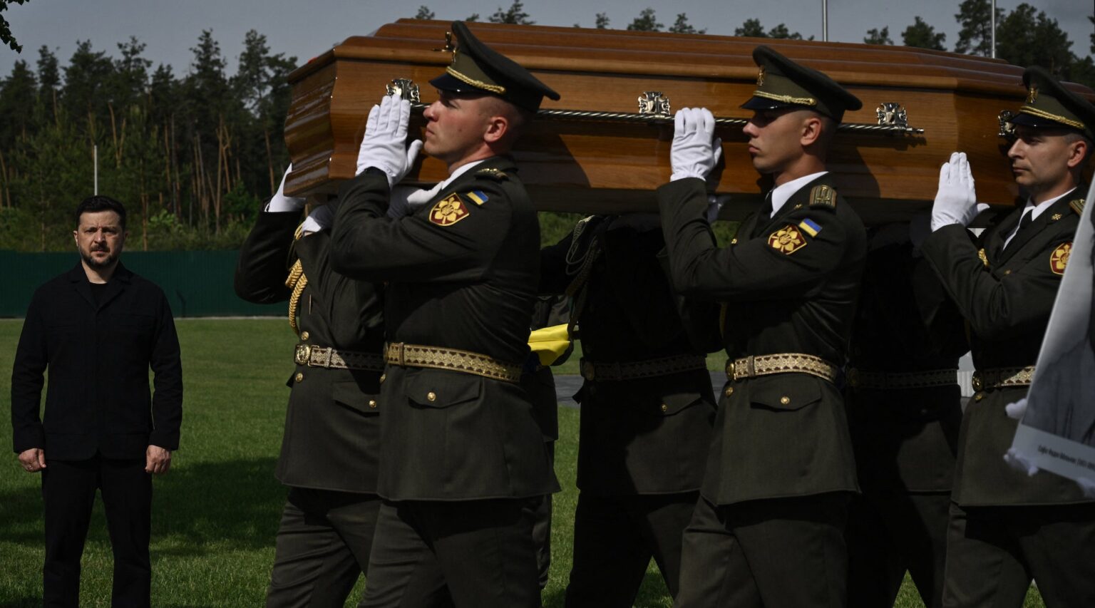 Ukraine reburies Nazi collaborator with state honors, drawing Israeli condemnation A photo of soldiers carrying a casket.