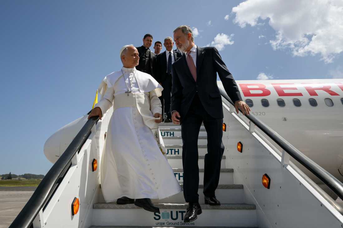 In this handout photo provided by Vatican Media, Pope Leo XIV is accompanied by King Felipe VI of Spain as he deplanes after a technical problem at Tenerife Norte-Los Rodeos International Airport in Tenerife, Spain, Friday, June 12, 2026.