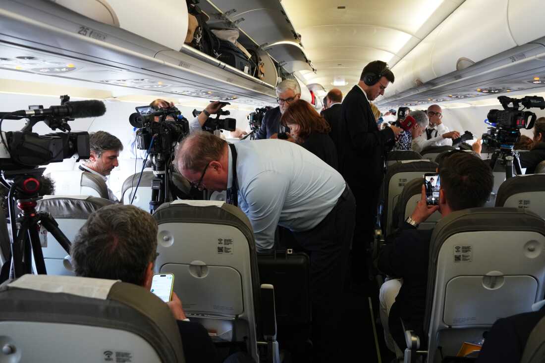 Journalists attend into the papal flight after takeoff was delayed at Los Rodeos International Airport, at the Canary Islands, Spain, Friday, June 12, 2026.