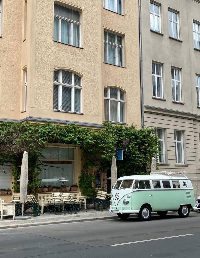Perfect Berlin aesthetic: historic buildings, green vines, and a classic VW bus