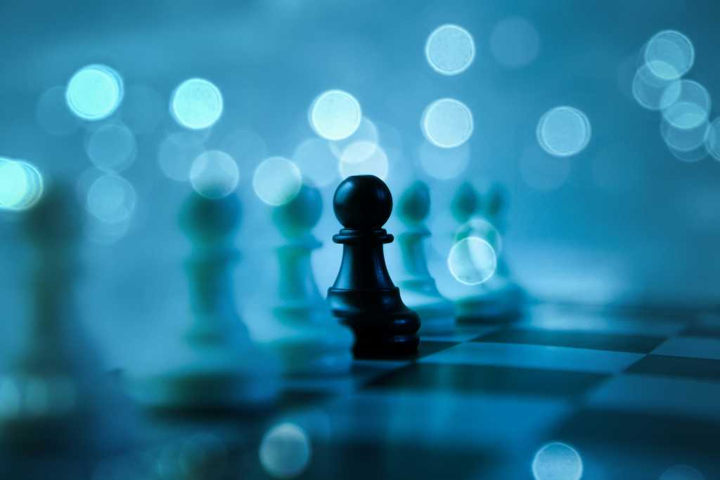 How AI agents are turning enterprise apps into decision systems A black pawn stands out on a chessboard, representing decision intelligence