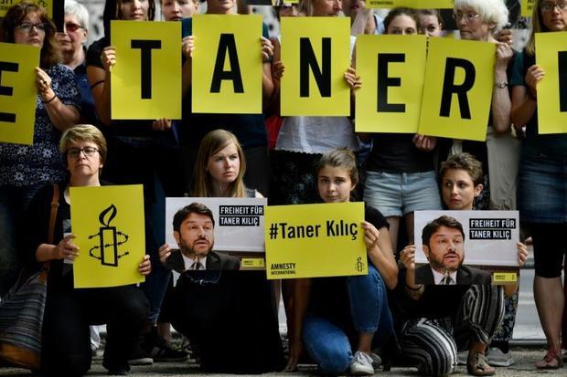 Activists from Amnesty International protest against the detention of the head of Amnesty Internatio...