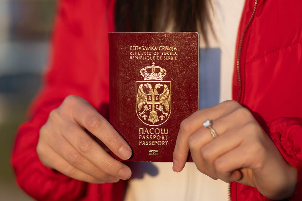 A woman holds a Serbian passport (Illustration), Photo: Shutterstock
