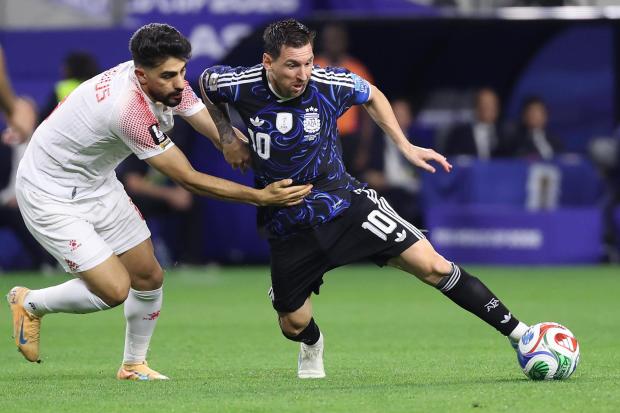 Argentina's Lionel Messi controls the ball against Jordan's Amer Jamous.
