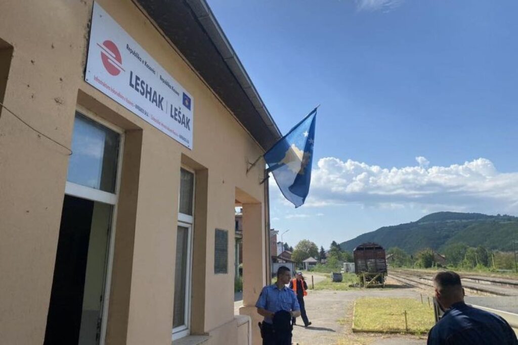 North Kosovo rail assets controlled by Infrakos Lešak rail station building with Kosovo flag and railway tracks in northern Kosovo under Infrakos control