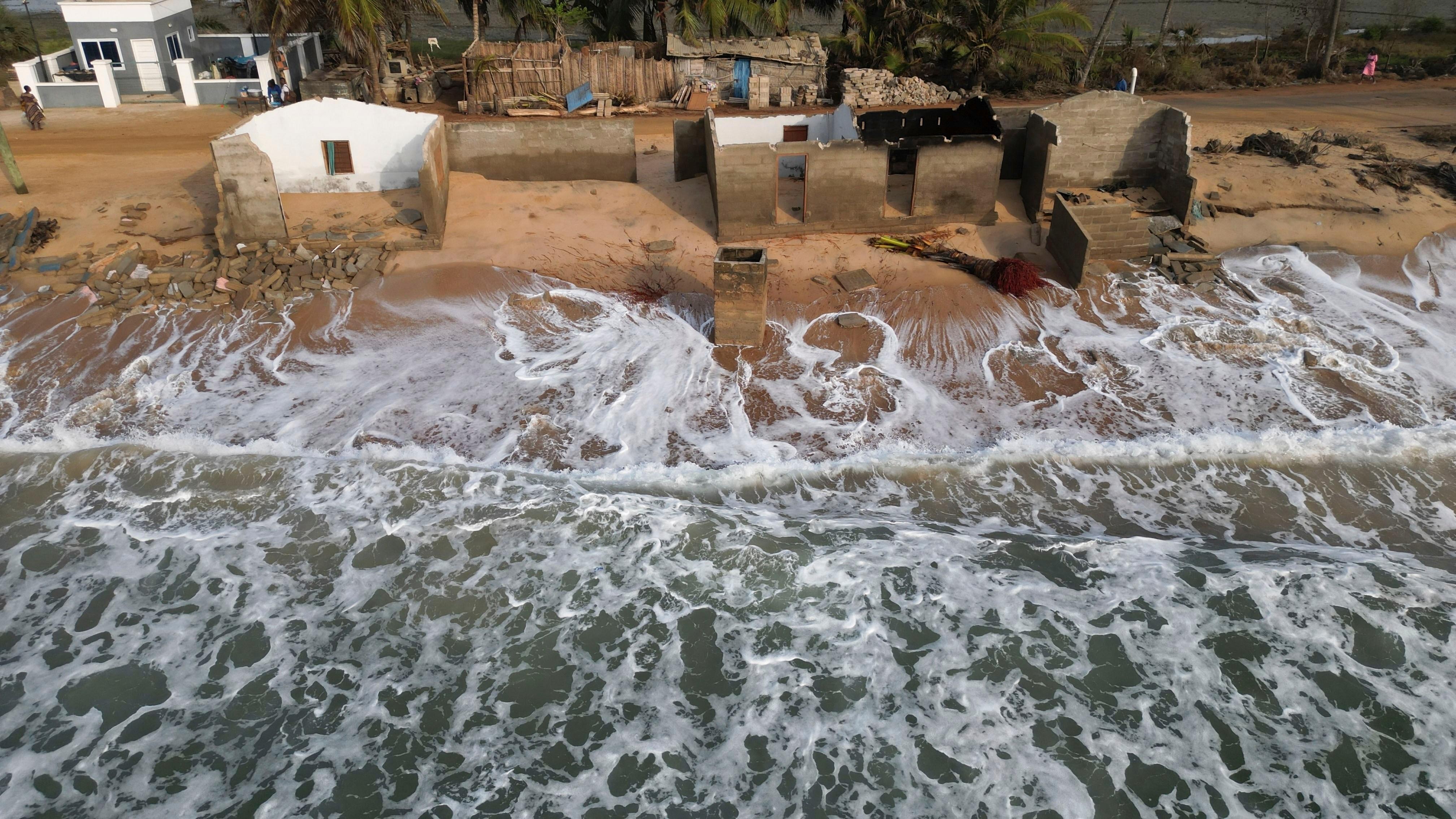 FILE – Waves lap the beach where remains of Afeli...