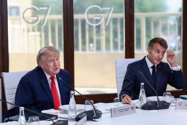 U.S. President Donald Trump, left, and French President Emmanuel Macron, right, attend a working lunch with leaders of G7 and the Middle East, in Evian-les-Bains, France, Tuesday, June 16, 2026. (Evelyn Hockstein/Pool Photo via AP)