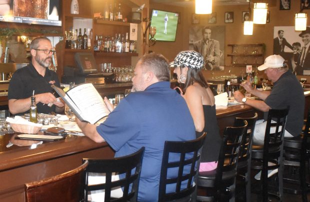 Patrons have the option of enjoying a libation or dining at the bar in Angeli's Restaurant in Naperville. (Steve Metsch/Naperville Sun)