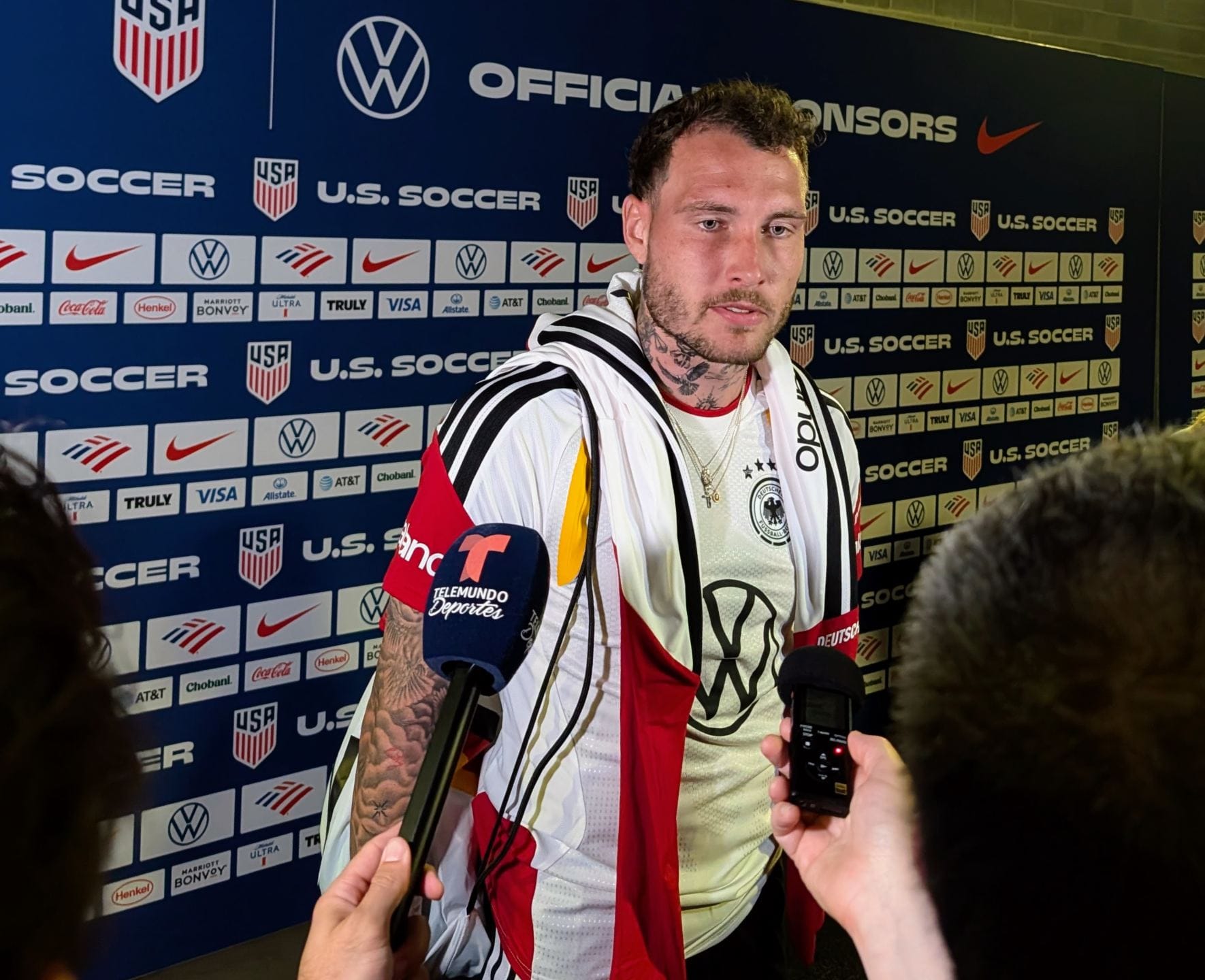 The German national team's David Raum speaks in the mixed zone following the match.
