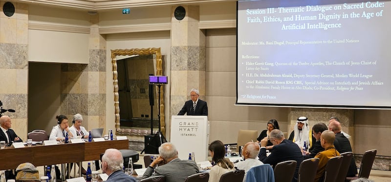Elder Gerrit W. Gong stands at a lecturn to give a presentation about artificial intelligence during a session of the World Council of Religions for Peace in Istanbul, Turkey, Tuesday, July 29, 2025.
