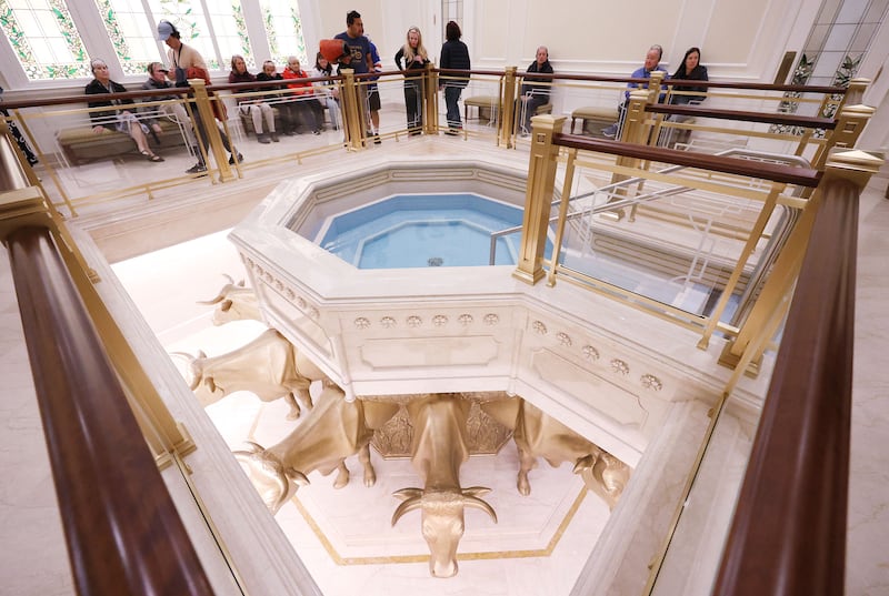 Attendees look over a baptismal font display at the new Temple Square Visitors’ Center in Salt Lake City on Monday, May 18, 2026.