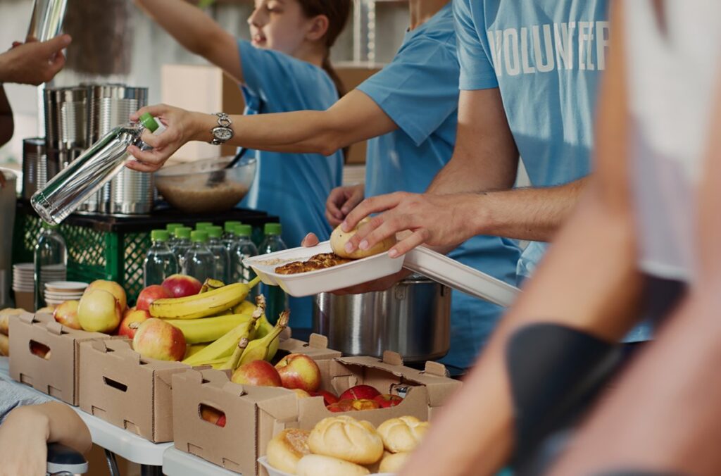 Study: Food security varies widely across U.S. ethnic groups | WSU Insider Volunteers serving meals at a food bank.