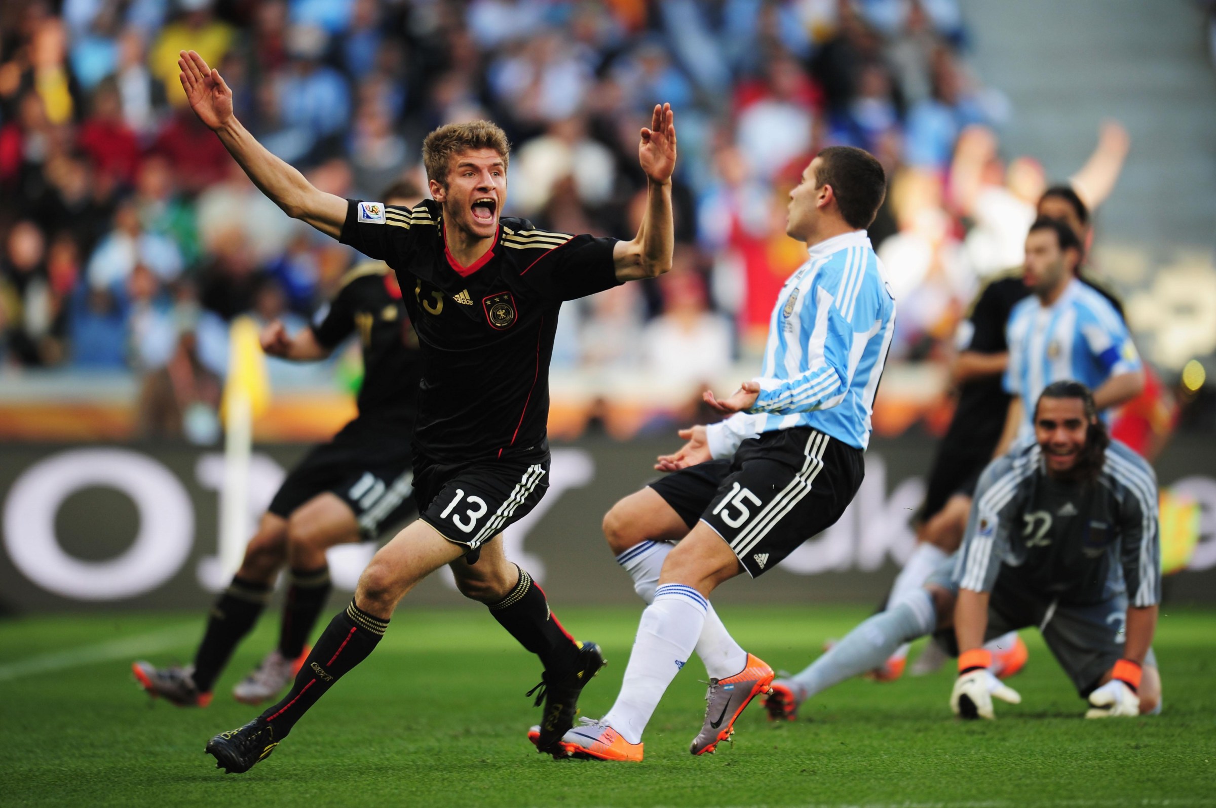 CAPE TOWN, SOUTH AFRICA - JULY 03: Thomas Mueller of Germany (L) celebrates scoring the opening goal during the 2010 FIFA World Cup South Africa Quarter Final match between Argentina and Germany at Green Point Stadium on July 3, 2010 in Cape Town, South Africa. (Photo by Shaun Botterill - FIFA/FIFA via Getty Images)