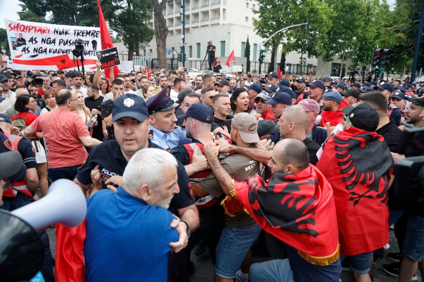 Protesters clash with police during a demonstration in front of the prime minister's office, against the construction of a luxury resort near a protected natural area, in Tirana on June 3, 2026.
