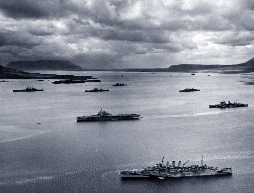 Allied warships of convoy PQ-17 at anchor in Hvalfjordur, Iceland, May-June 1942, including USS Washington, HMS Victorious, and HMS Norfolk.