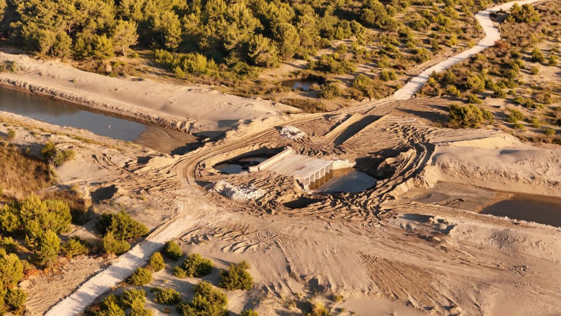 A photo provided by the conservation group PPNEA shows what they say is work already carried out at the site, including heavy machinery digging up the beach and trucks laying gravel.