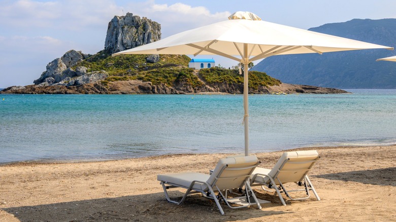 A set of beach chairs with umbrella in Agios Stefanos Beach, Kos