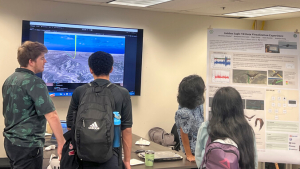 people looking at a poster board