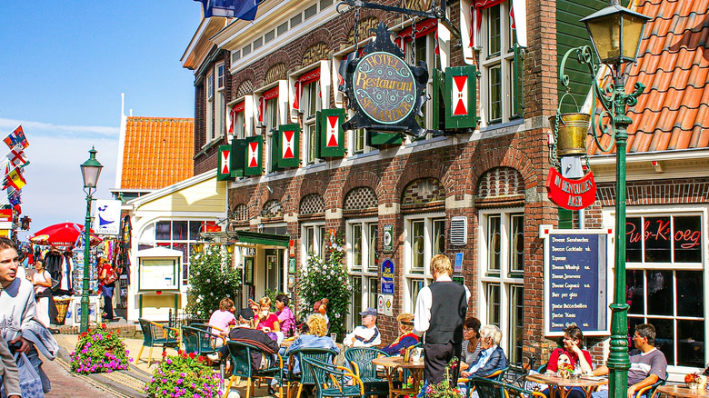 People sitting at an outdoor cafe outside the Hotel Spaander in Volendam, the Netherlands