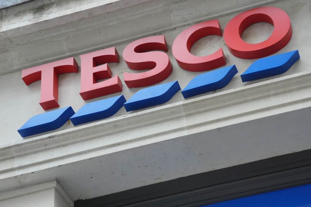 Tesco ‘in talks’ to ditch European operations Tesco storefront with shoppers entering and exiting, highlighting the brands popularity and bustling retail environment