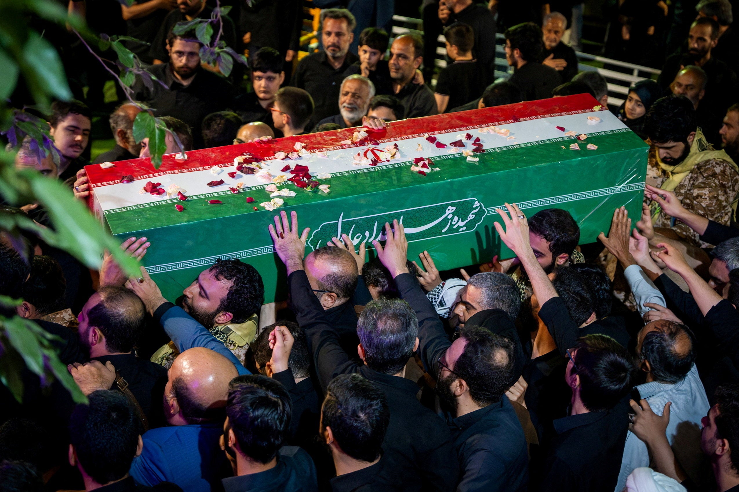 Mourners attend a farewell ceremony for Zahra Haddad Adel, wife of Iran's Supreme Leader Mojtaba Khamenei, who was killed on February 28 in Israeli and U.S. airstrikes, in Tehran, Iran, in this handout image released on July 2, 2026.