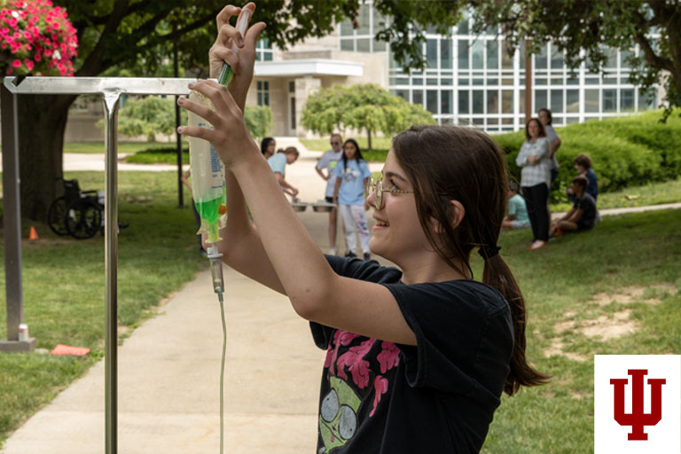 A girl holds an IV