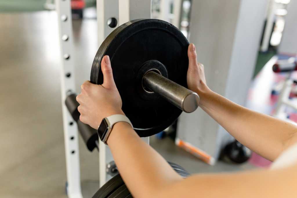 Will open weights make AI more honest? woman putting weight on barbell
