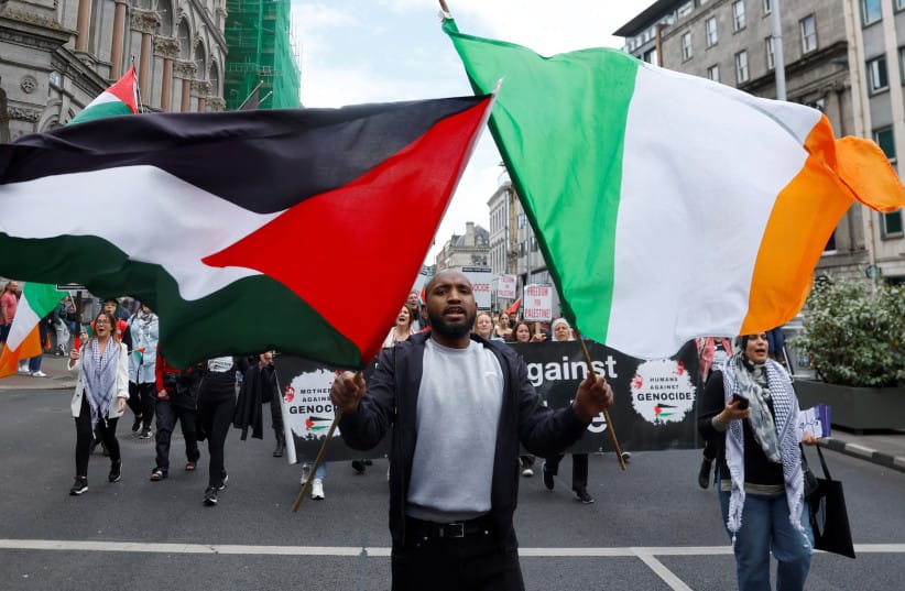 A man holds Irish and Palestinian flags as people protest calling for governments around the world to stop arming Israel during a demonstration in solidarity with Palestinians in Gaza, amid the ongoing conflict between Israel and Hamas, in Dublin, Ireland, June 15, 2024