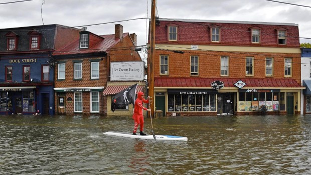 A paddle on a flooded downtown Annapolis. The City is spending $87 million on the City Dock Resiliency Project, the largest infrastructure project in the city's history, to combat flooding which has greatly increased in frequency and depth from sea level rise linked to global warming. (The Capital/File)