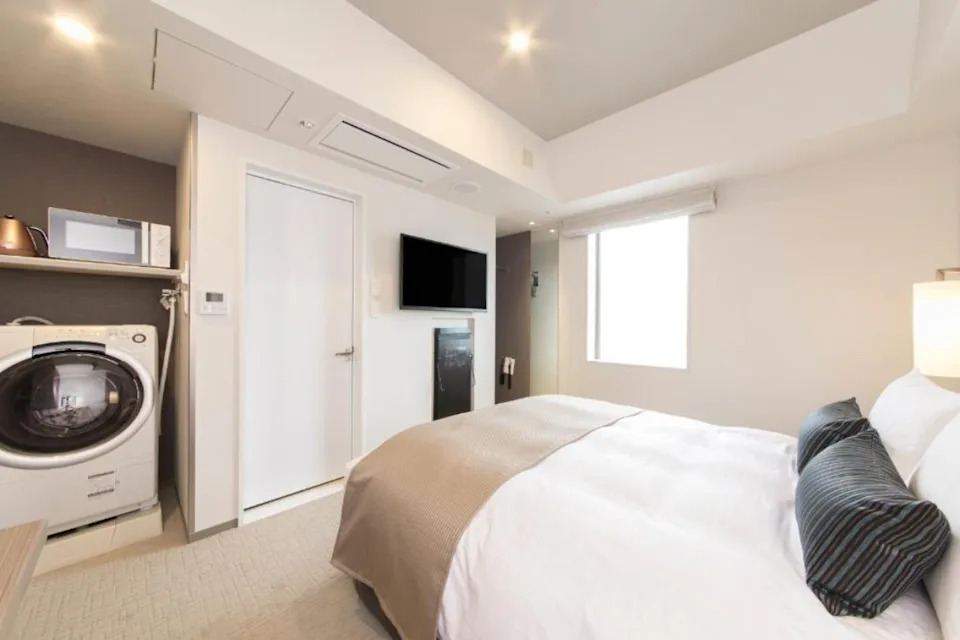 japan - hotel room with washer and bed
