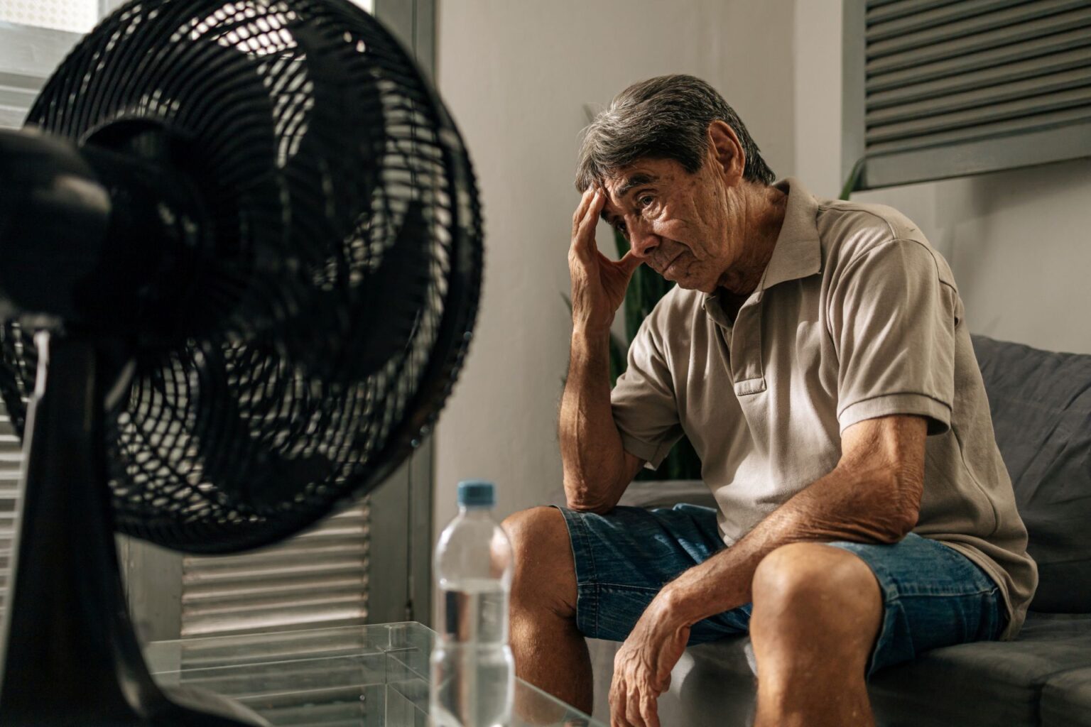US, Canada heat wave deemed ‘virtually impossible’ without climate change, and blame battle follows An elderly person sits in front of a fan in a heat wave.
