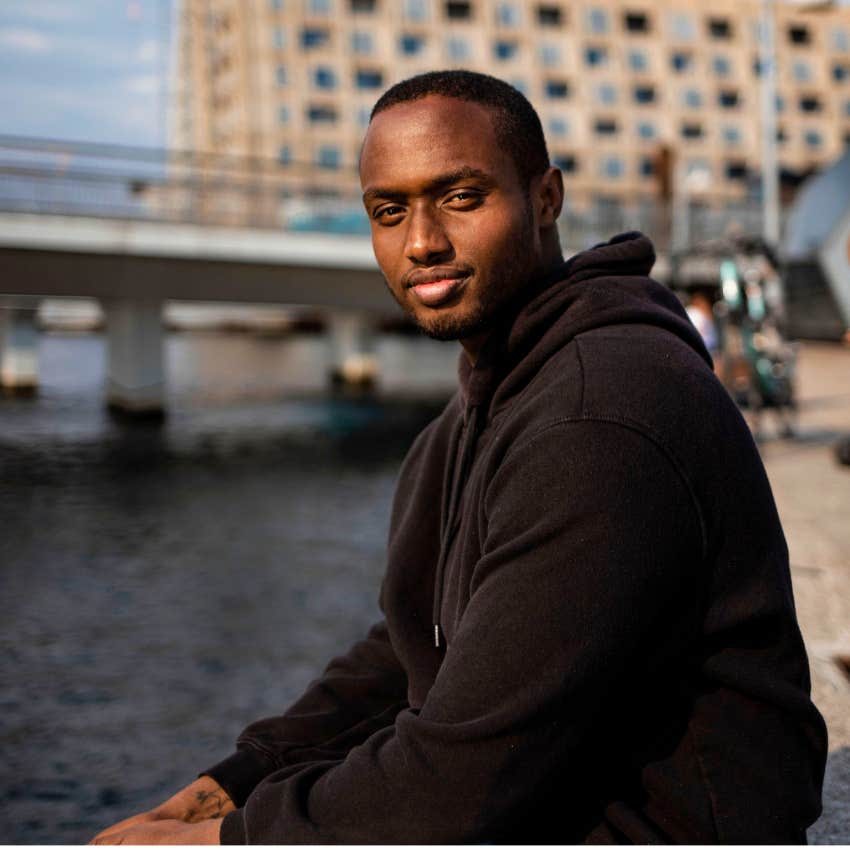 authentic man sitting near the water in copenhagen denmark