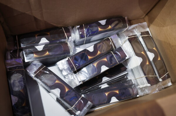 Special protective glasses for viewing the sun are stored in a cardboard box at the Hamburg Planetarium on Wednesday, Aug. 12, 2026 in Hamburg, Germany. (Christian Charisius/dpa via AP)